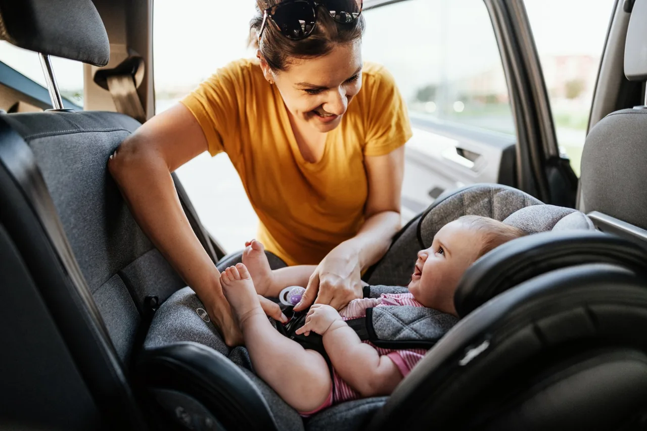 Rear-facing child car seat secured in a Henderson Taxi vehicle for an Auckland Airport transfer